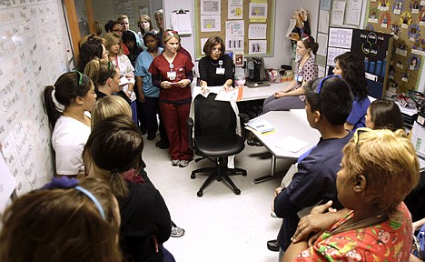 &lt;p&gt;University of Maryland Medical Center infection control specialist Michael Anne Preas, center, talks with ICU nurses about infection control Nov. 17 in Baltimore.&lt;/p&gt;