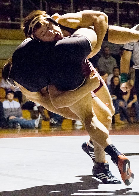 <p>North Idaho College's Jeremy Golding tosses Northwest Wyoming College's Jake McCormick to the mat in the 149-pound match.</p>