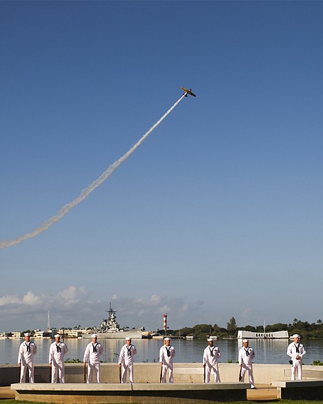<p>A vintage WWII airplane files over the USS Arizona at the ceremony commemorating the 72nd anniversary of the attack on Pearl Harbor, Saturday in Honolulu.</p>