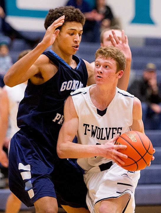 &lt;p&gt;Lake City's Duncan Butler looks towards the basket as Gonzaga Prep's Anton Watson defends on Tuesday at Lake City High School.&lt;/p&gt;