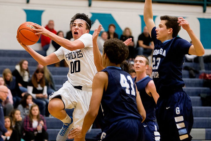 &lt;p&gt;Lake City's Kenneth Louie-McGee drives for a lay-up past Gonzaga Prep's Anton Watson (41) and Brandon Bieber (23) in the second quarter on Tuesday at Lake City High School.&lt;/p&gt;