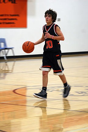 Brandyn Smith pushing the ball in transition for his black team, which lost the scrimmage 51-36.