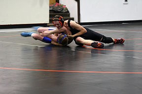Ted Beech wrestling his opponent to the mat.