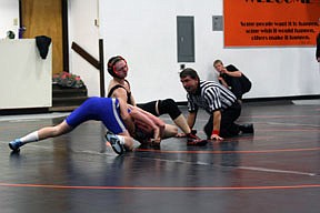 Ted Beech versus Wyatt Jessop of Corvallis. Head coach Kenny Margerrison watches in the background.