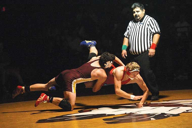 Moses Lake's Nico Hernandez, maroon, takes down his opponent from Eastmont during a dual Thursday. Hernandez recorded a technical fall.