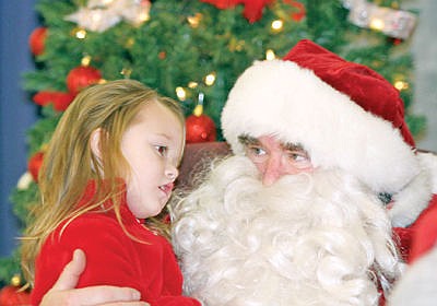 &lt;p&gt;Lexi Porteus chats with Santa Saturday during the kiddie carnival at Asa Wood.&lt;/p&gt;