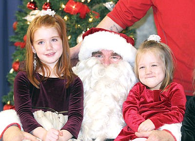 &lt;p&gt;Alexia Goucher, left, and Christina Goucher meet Santa during the kiddie carnival at Asa Wood Saturday evening.&lt;/p&gt;