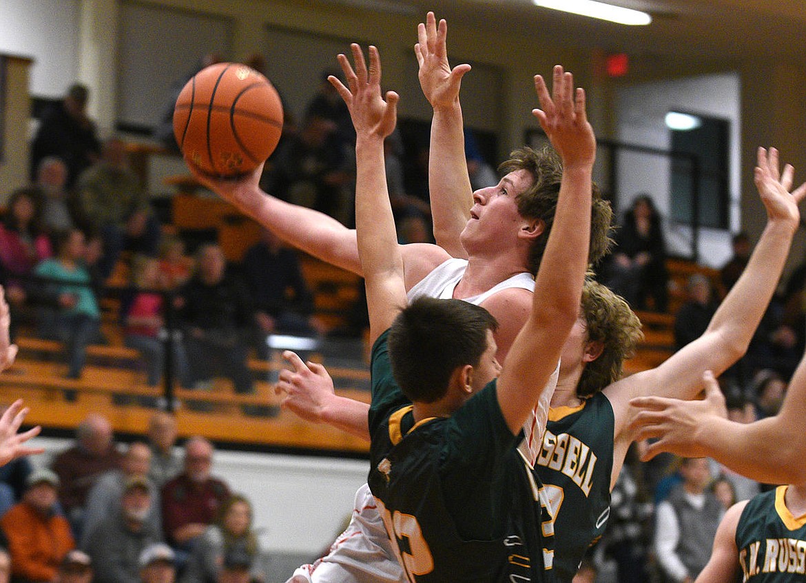 &lt;p&gt;Flathead guard Eric Seaman puts up a shot between two Rustler defenders during the first quarter at Flathead on Friday. (Aaric Bryan/Daily Inter Lake)&lt;/p&gt;