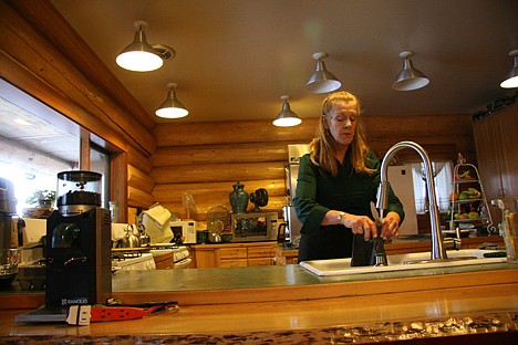 &lt;p&gt;Log Spirit Bed and Breakfast owner Robin McKellar cleans up a bit before more guests arrive to her home for the annual North Idaho Bed and Breakfast Association's Holiday Open House.&lt;/p&gt;