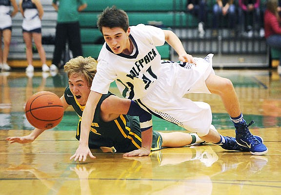 &lt;p&gt;Glacier&#146;s Dylan Ruggles (21) and Whitefish&#146;s Cody Olson dive for a loose ball during the final minutes of a December 20, 2014 basketball game at Glacier High School. (Aaric Bryan/Daily Inter Lake)&lt;/p&gt;