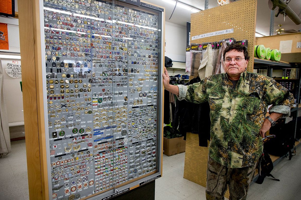 &lt;p&gt;Army and Navy Outdoor owner Phil Motl poses next to a expansive collection of more than 10,000 pins from various divisions of the United States military that are for sale in the store. After investing thousands of dollars into the collection, he hasn't yet found a place for the pins for when the store closes in the coming months.&lt;/p&gt;