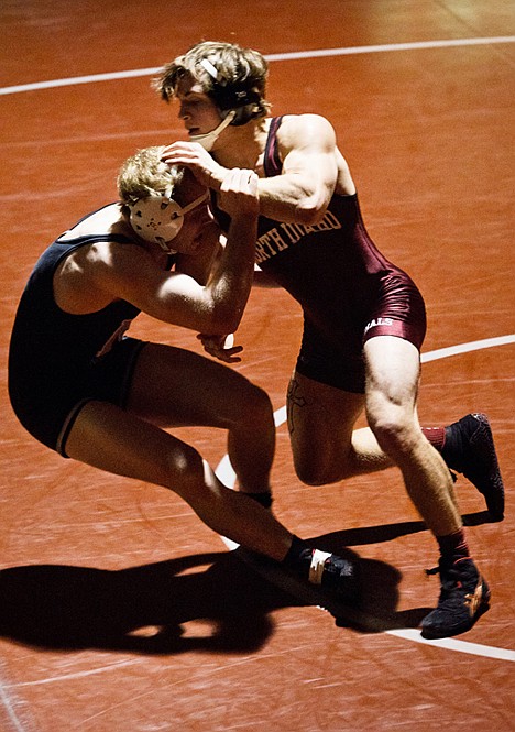 <p>Ryan Zumwalt, 157-pounder for NIC, drives Northwest College's Jaksen Cotterell backward onto the mat.</p>