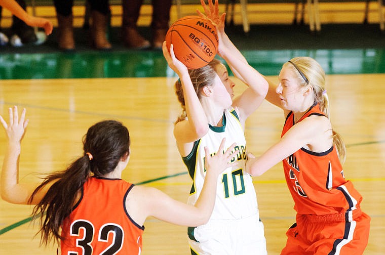 &lt;p&gt;Flathead defenders Tiana Johnson and Lizzie Sherwood surround Whitefish guard Allie Schulz Tuesday night during Flathead's victory over Whitefish at Whitefish High School. Dec. 10, 2013 in Whitefish, Montana. (Patrick Cote/Daily Inter Lake)&lt;/p&gt;