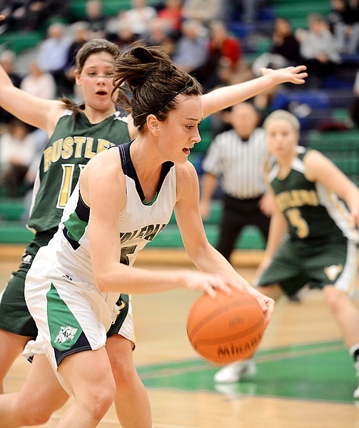 <p>Glacier's Rachel Chery, 5, pushes past a C.M. Russell defender during their game on Friday night in Kalispell. Glacier won the match up 49-43.</p>