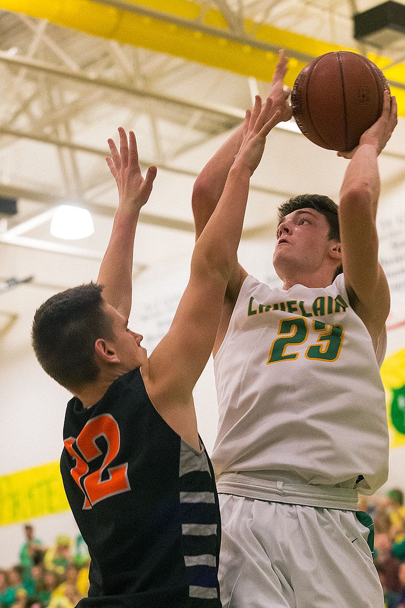 <p>Lakeland forward Forest Zubaly (23) goes over Post Falls David Bourgard for a second quarter score.</p>