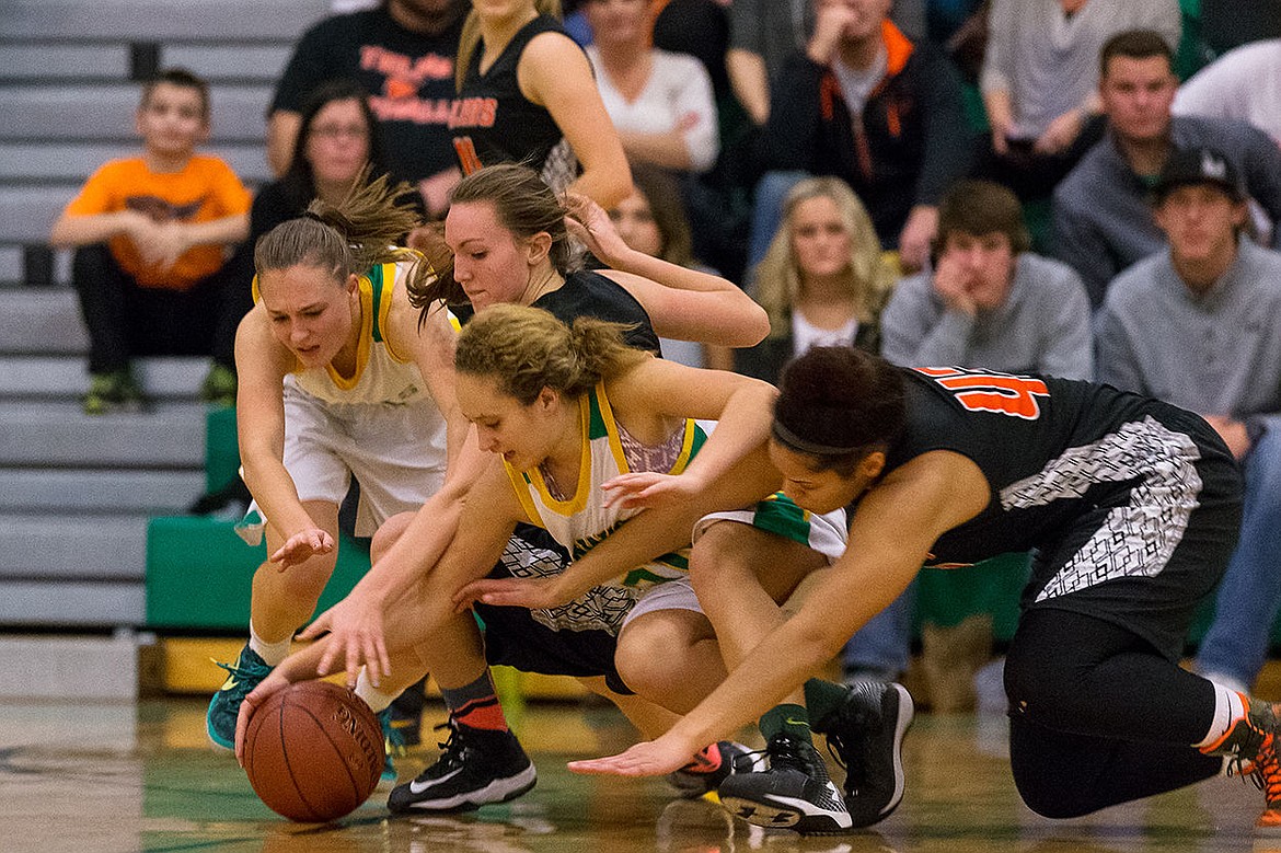 &lt;p&gt;From left, Lakeland High&#146;s Tauna Kirk and Brittany Charles battle Post Falls&#146; Glory Ellison and AubreAnna Johnson for a loose ball during the second quarter.&lt;/p&gt;