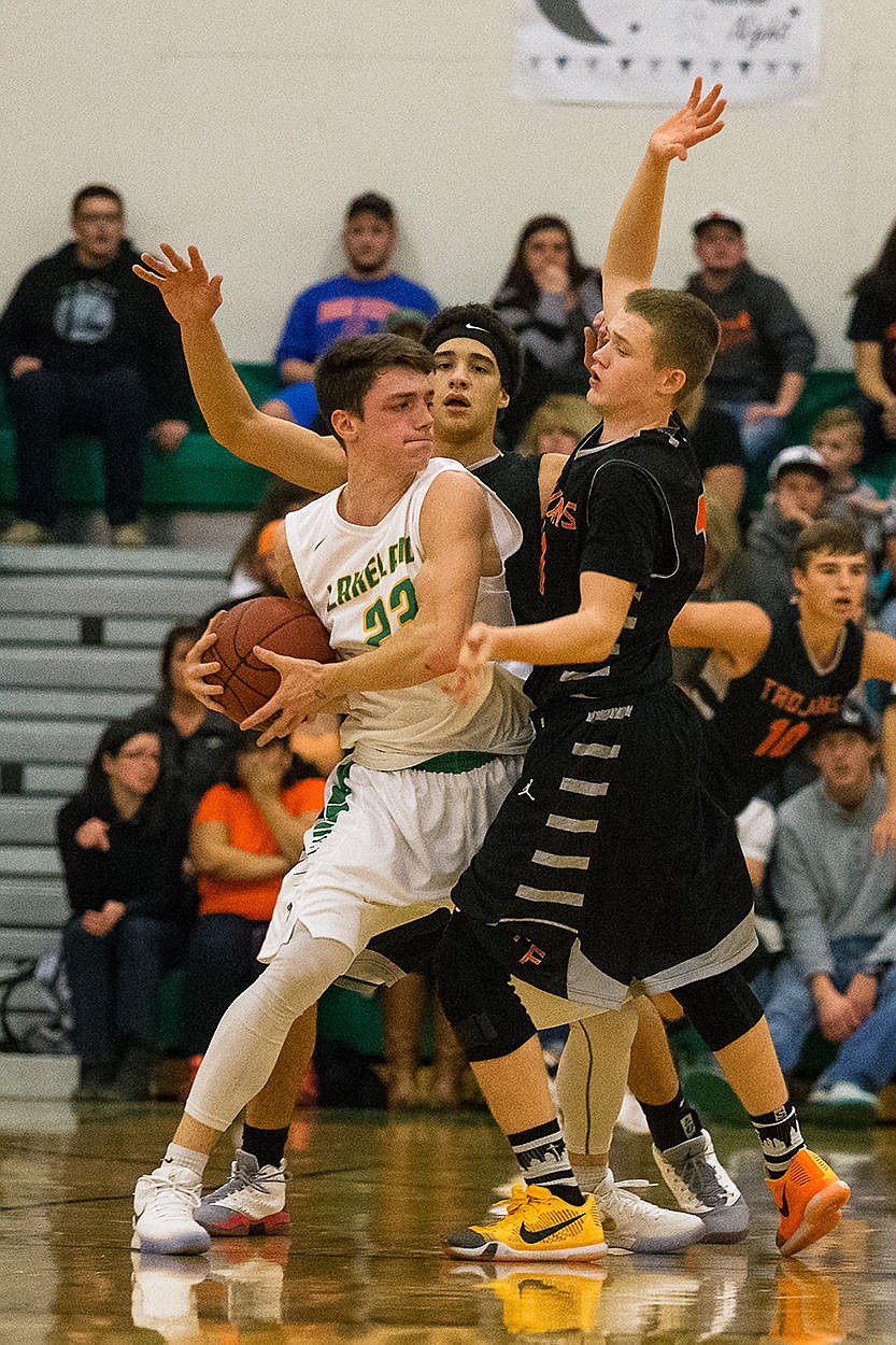 <p>Lakelands Forest Zubaly looks for a passing option against Post Falls defenders Jayden Gering, center, and Tanner McCliment-Call, left, during the first half.</p>