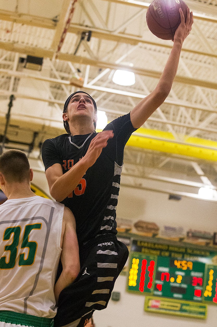 <p>Post Falls Jacob Pfennings goes up for a lay-up against LakelandsAndrew Knight.</p>