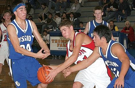 Photo by Sarah Leavenworth&lt;br&gt;Mission defenders swarm around Noxon senior Peter Ferrell Friday. Noxon was undefeated for the tournament, notching wins over Mission and Eureka.