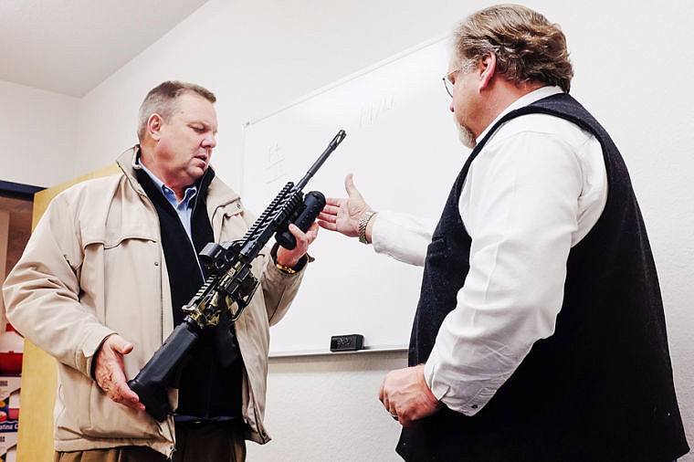 &lt;p&gt;Sen. Jon Tester, left, holds a rifle while Gary Byers points out the Pro-Defense F4 Tactical kit, a rail-mounted pepper spray system manufactured by Creative Sales Company. Dec. 3, 2013 in Columbia Falls, Montana. (Patrick Cote/Daily Inter Lake)&lt;/p&gt;