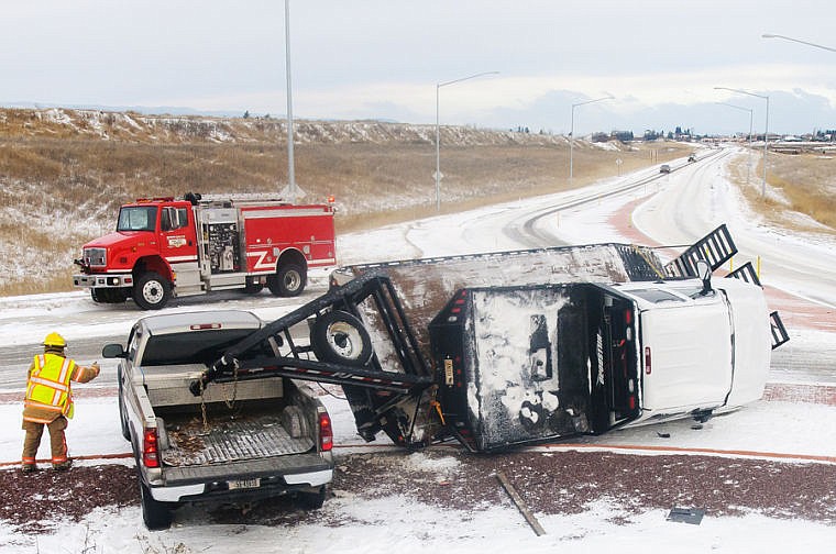 &lt;p&gt;Smith Valley firefighters respond to the site of a rollover Tuesday morning. A gooseneck trailer flipped at the roundabout on the U.S. 93 Alternate Route at Foy&#146;s Lake Road in Kalispell.&lt;/p&gt;