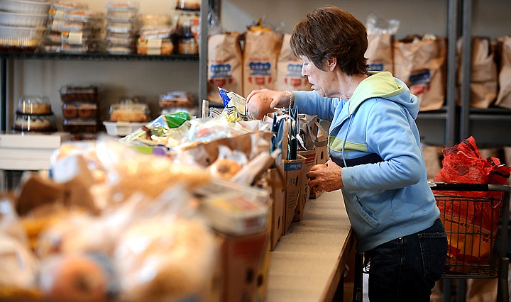 &lt;p&gt;Carole Moseley of Whitefish, a volunteer, prepares boxes for distribution on Thursday, December 5, at the North Valley Food Bank in Whitefish. (Brenda Ahearn/Daily Inter Lake)&lt;/p&gt;