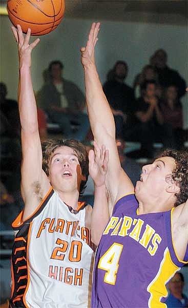 Chris Jordan/Daily Inter Lake&lt;br&gt;Jordan Lister of Flathead drives past Collin Thomas of Missoula Sentinel during Flathead's 57-55 loss in Kalispell Friday.