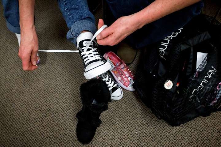 &lt;p&gt;Tracie Anderson ties a new shoe for Sydney Adams as they shop for footwear.&lt;/p&gt;
