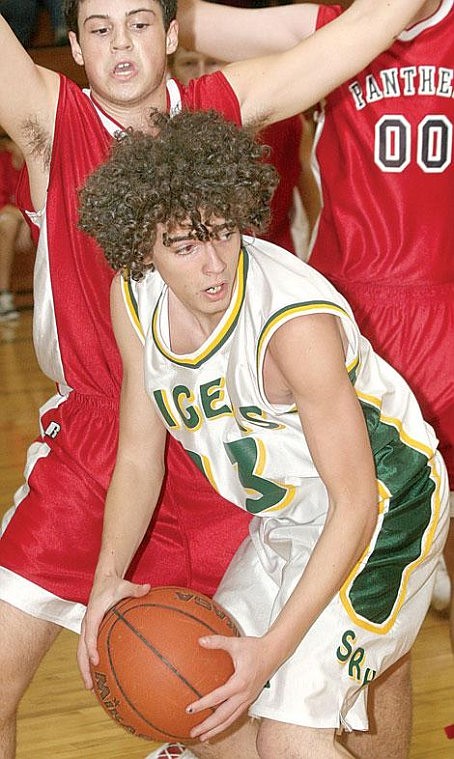 Photo by Aaric Bryan&lt;br&gt;St. Regis' Patrick Quinlivan looks for somebody to pass to after pulling down a rebound against the CDA Panthers at the Tiger Tail Tournament Friday in St. Regis.