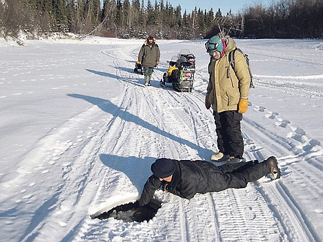 &lt;p&gt;In this photo provided by the University of Alaska, Sam Dementieff checks a hole in the ice on the Tanana River as Dave Norton looks on and Knut Kielland approaches.&lt;/p&gt;