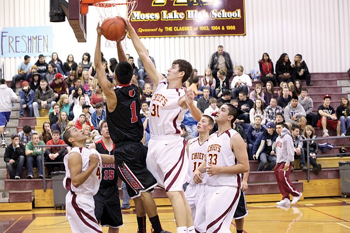 The Chiefs Denis Ulyanchuk (31) blocks a layup attempt by the
Grizzlies Oscar Medina during Friday nights game in Moses Lake.