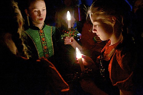 &lt;p&gt;Lizzie Benson, 16, left is illuminated by the battery-powered candles held by Bridget Erb, 12, and other performers during a dress rehearsal Monday for the &quot;Traditions of Christmas&quot; musical at the Kroc Center in Coeur d'Alene.&lt;/p&gt;