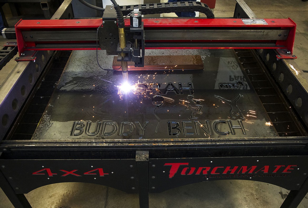 &lt;p&gt;An electronic Torchmate cuts details into a bench for Borah Elementary School on Tuesday at Kootenai Technical Education Campus. Elementary students learn that if they see someone on the Buddy Benches, that person is in need of some kindness and friendship.&lt;/p&gt;