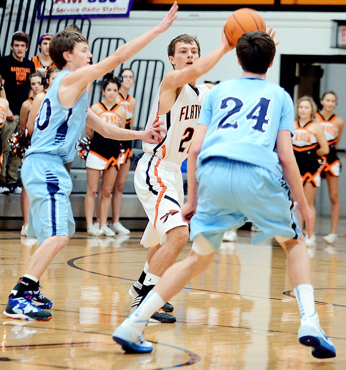 &lt;p&gt;Flathead senior Will Cronk (22) attempts to pass the ball while pressured by Great Falls&#146; Matthew Wyman (24) and Bryce Clark (left) during Saturday&#146;s Class AA nonconference basketball game at Flathead High School.&lt;/p&gt;