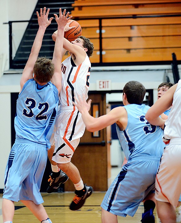 &lt;p&gt;Flathead senior Chandler Escalante (23) puts up a shot over Brendan Howard (32) of Great Falls during the first half of Saturday&#146;s game at Flathead.&lt;/p&gt;