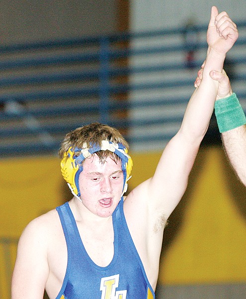 An official raises Gunnar Moe's hand in victory on Thursday against Bonners Ferry.