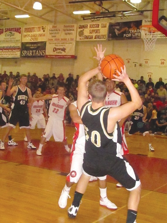 Tight checking by Granger forces Royal's Carter Christensen, 50,
to bend backward and look for an open man.