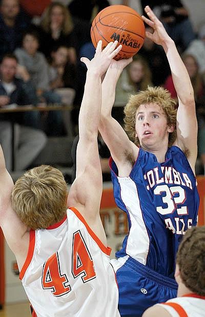 Craig Moore/Daily Inter LakeColumbia Falls' Michael Taylor (32) goes up for a basket while Flathead's Brad Huff (44) defends on the play during the second half of Thursday night's basketball game held at Flathead High School.