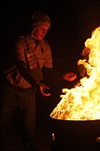 Ben French places a retired flag into the fire during the ceremony on last Tuesday.