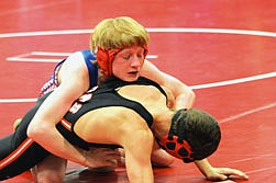 Superior wrestler River Sides works his man on the mat during Friday night's match.