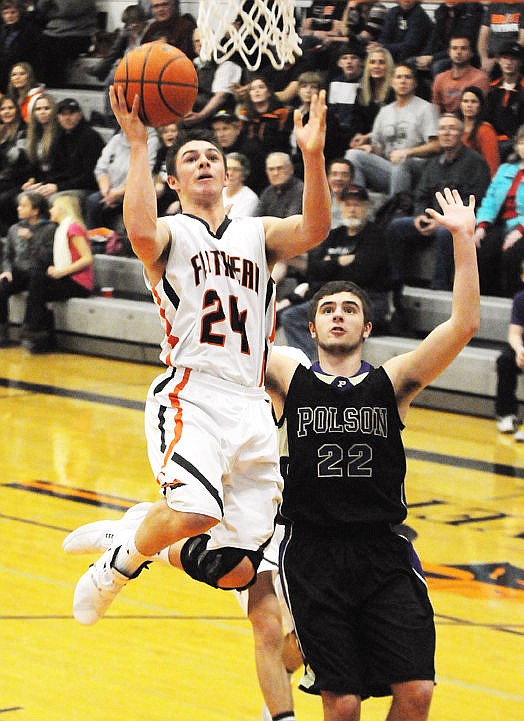 &lt;p&gt;Flathead's CJ Dugan sails past Polson's Tanner Wilson for a layup during the first quarter at Flathead Tuesday. (Aaric Bryan/Daily Inter Lake)&lt;/p&gt;