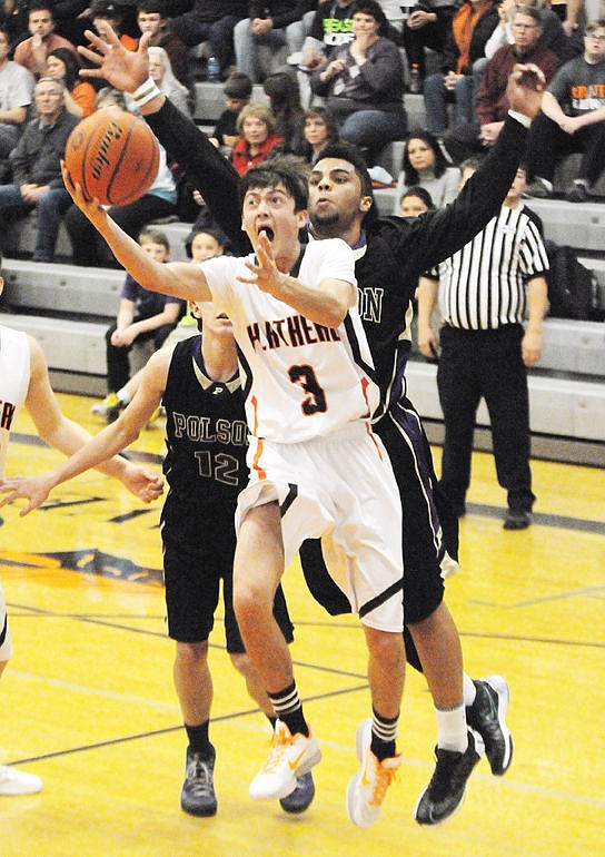 <p>The Braves' Matt Marshall drives past the Pirates' Julian Jones for a basket against Polson on Tuesday. (Aaric Bryan/Daily Inter Lake)</p>