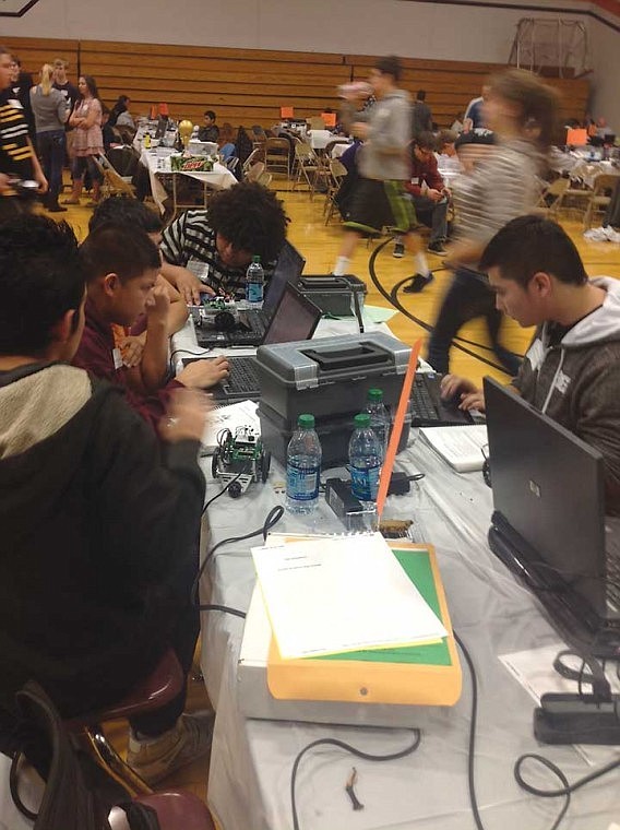 Miguel Quintero, Elian Rivera, Manuel Soto, David Torres, and Toby Martinez, the 5th World Warriors of Wahluke, work feverishly to program their robot.