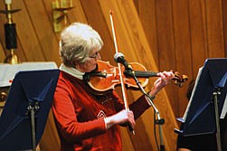 Glenna Cook plays the violin in a duet on Monday night at the community Christmas program.