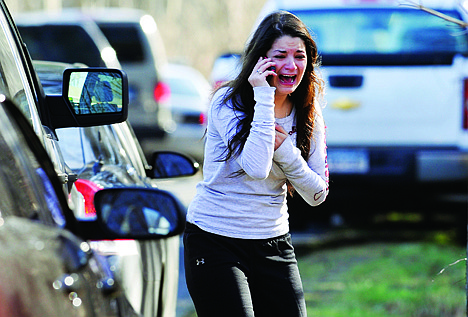 &lt;p&gt;A woman waits to hear about her sister, a teacher, following a shooting at the Sandy Hook Elementary School in Newtown, Conn. where authorities say a gunman opened fire, leaving 27 people dead, including 20 children, Friday.&lt;/p&gt;