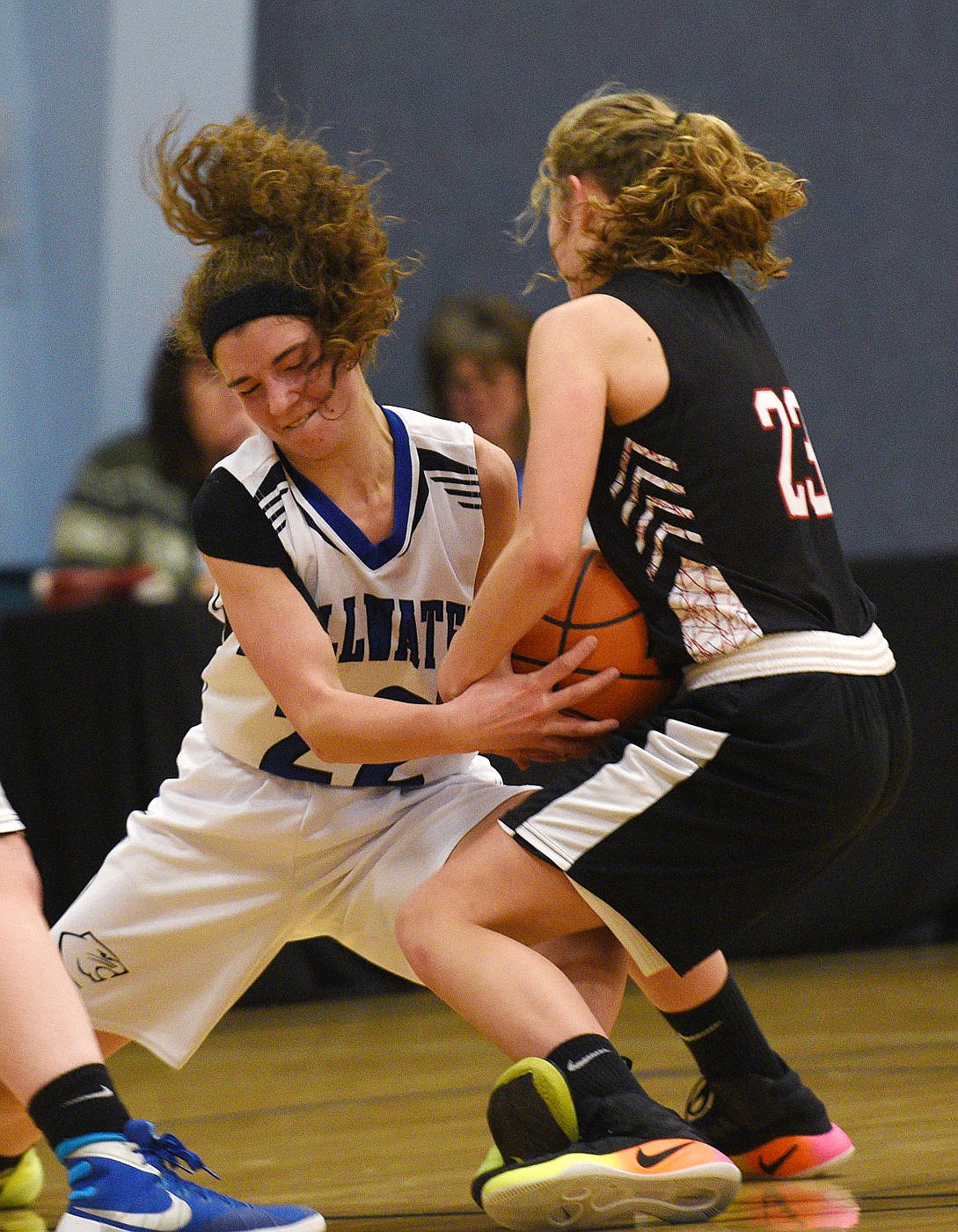 <p>Stillwater Christian senior Dori Smith and Flathead Valley Homeschool sophomore Cassidy Husted fight for a loose ball. (Aaric Bryan/Daily Inter Lake)</p>
