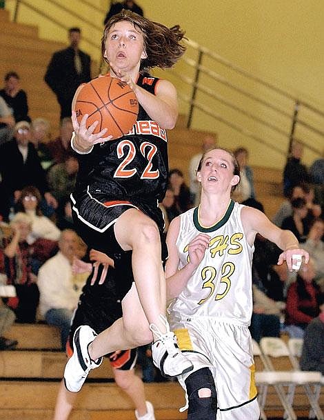 Flathead&#146;s Meghan O&#146;Connell goes up for the basket as Whitefish guard Chelsea Ray defends during second-half play Friday night in Whitefish. Flathead won 74-43. Karen Nichols /Daily Inter Lake