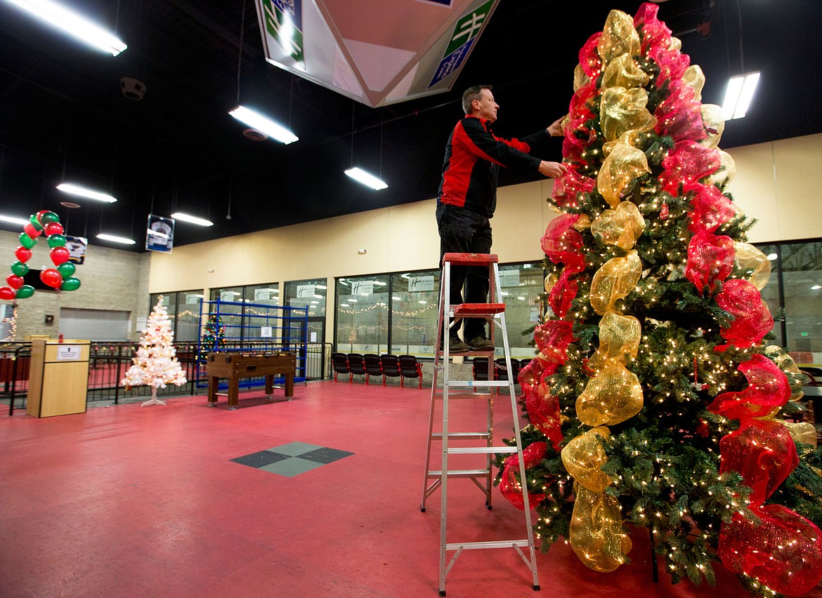 &lt;p&gt;Bill Harryman, who works maintenance at the Frontier Ice Arena, adjusts decorations on a Christmas tree on Thursday in preparation for the ice rink&#146;s annual 12 Skates of Christmas event.&lt;/p&gt;