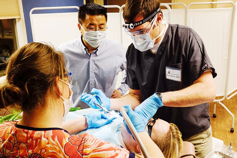 &lt;p&gt;Dr. David Keim, right, extracts a tooth from Angela Sutton&#146;s mouth Monday night during the Shepherd&#146;s Hand Clinic at Christ Lutheran Church in Whitefish. (Patrick Cote/Daily Inter Lake)&lt;/p&gt;