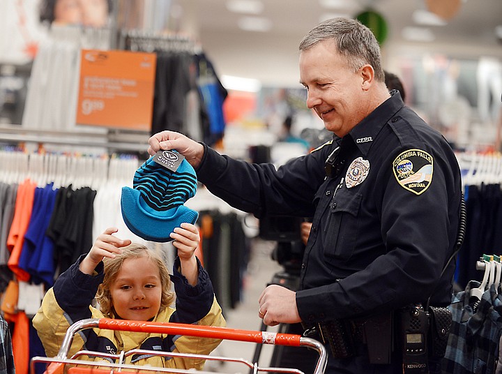 &lt;p&gt;Gary Stanberry and Braden Kearney, 7, pick out items at the annual Shop with a Cop event on Wednesday, December 11, at Target in Kalispell. (Brenda Ahearn/Daily Inter Lake)&lt;/p&gt;